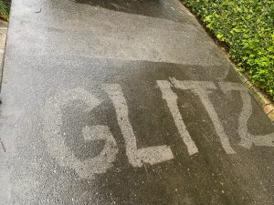 Glitz Logo pressure washed into the dirt