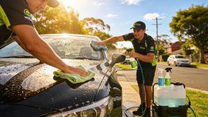 A photo of the Glitz Crew cleaning a car