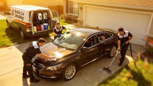 Mobile car detailing team servicing a vehicle at a customer's location in Sydney