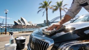 Premium car detailing services in Sydney with a technician working on a luxury vehicle